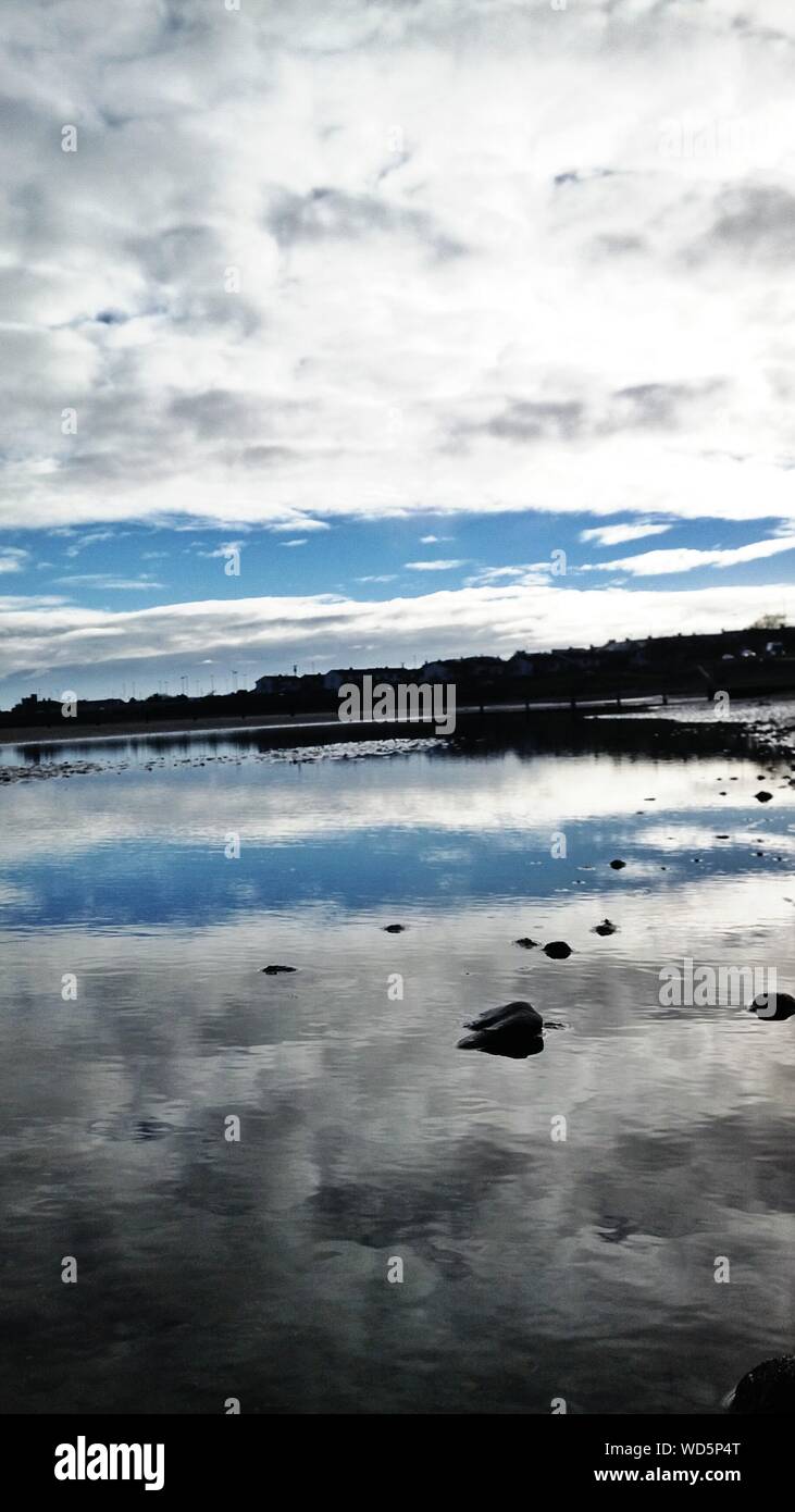 Cloudy sky reflected in water hi-res stock photography and images - Alamy
