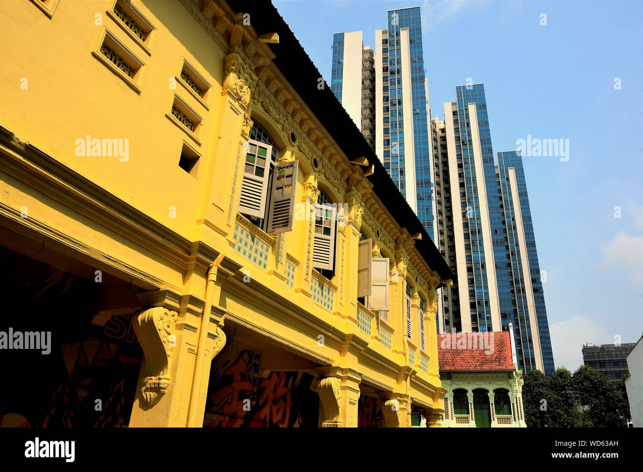 Perspective view of colourful old Singapore shophouses with background of modern apartment towers in historic Jalan Besar Stock Photo
