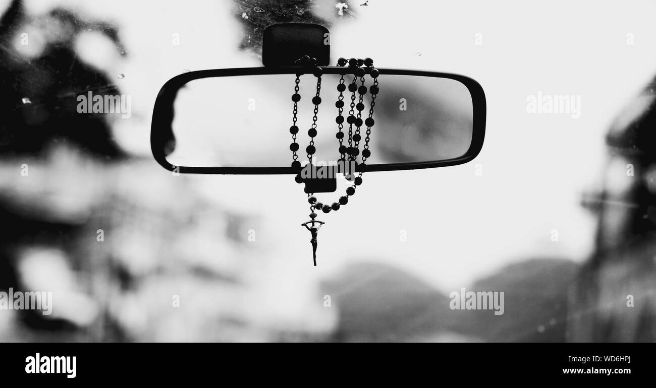 Cross on rear view mirror hi-res stock photography and images - Alamy