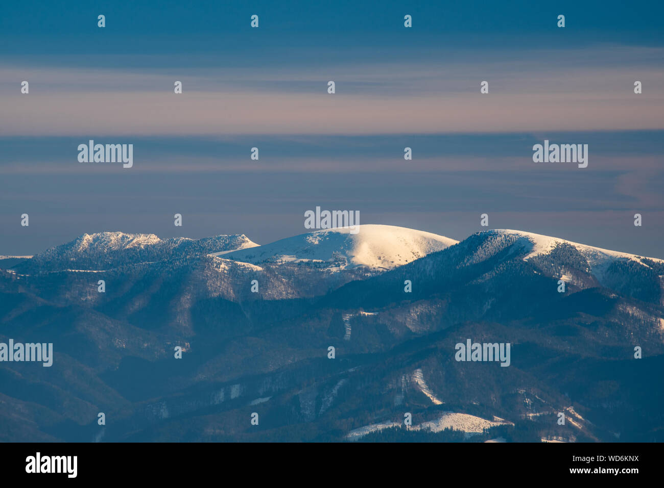 view to Cierny kamen, Ploska and Borisov hills from Martinske hole in Mala Fatra mountains in Slovakia during winter day with blue sky Stock Photo