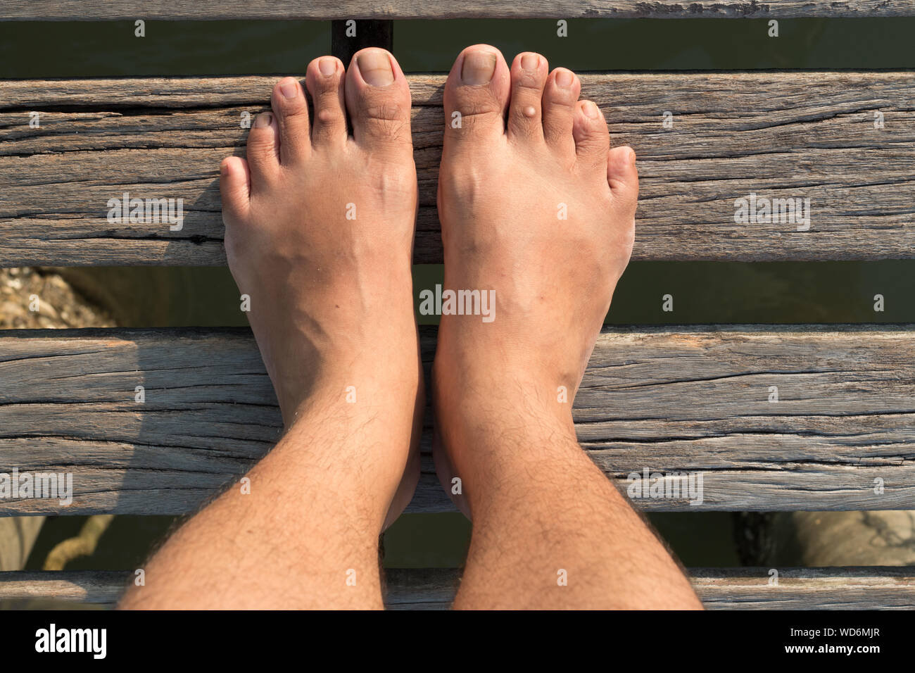 Low Section Of Man Standing Barefoot Stock Photo