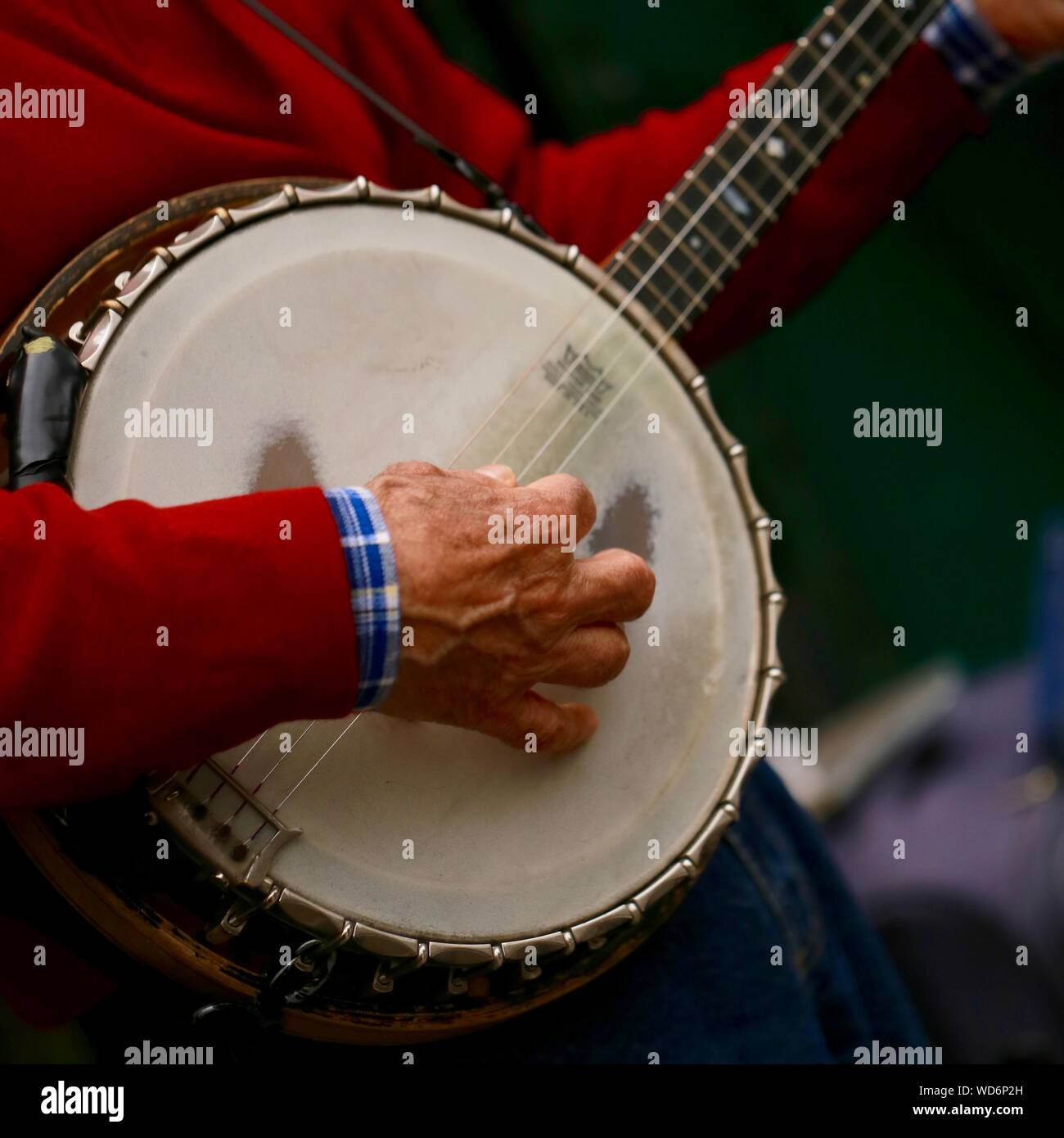 Midsection Of Man Playing Banjo Stock Photo