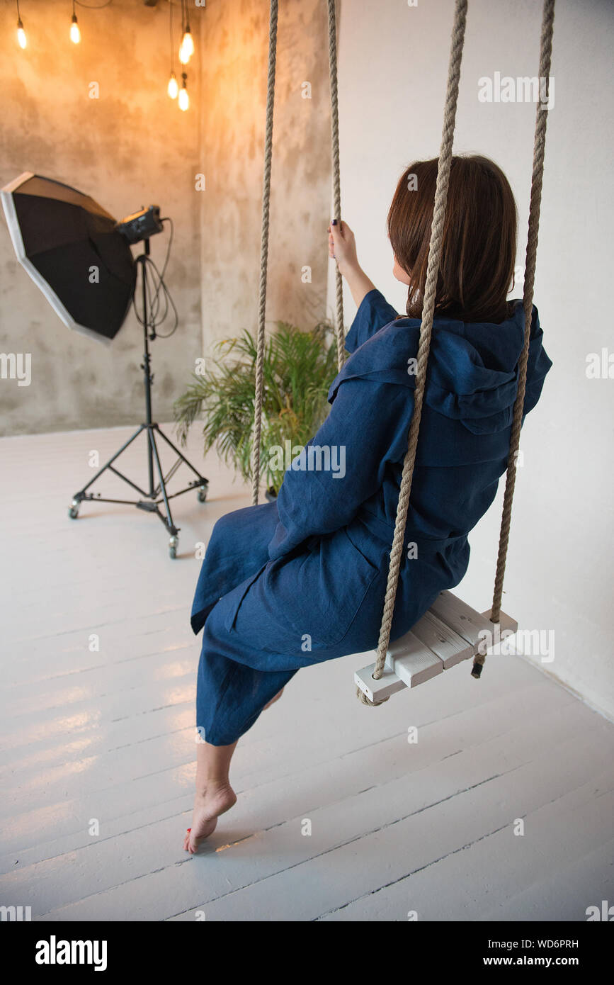 Mid Adult Woman Sitting On Swing Stock Photo