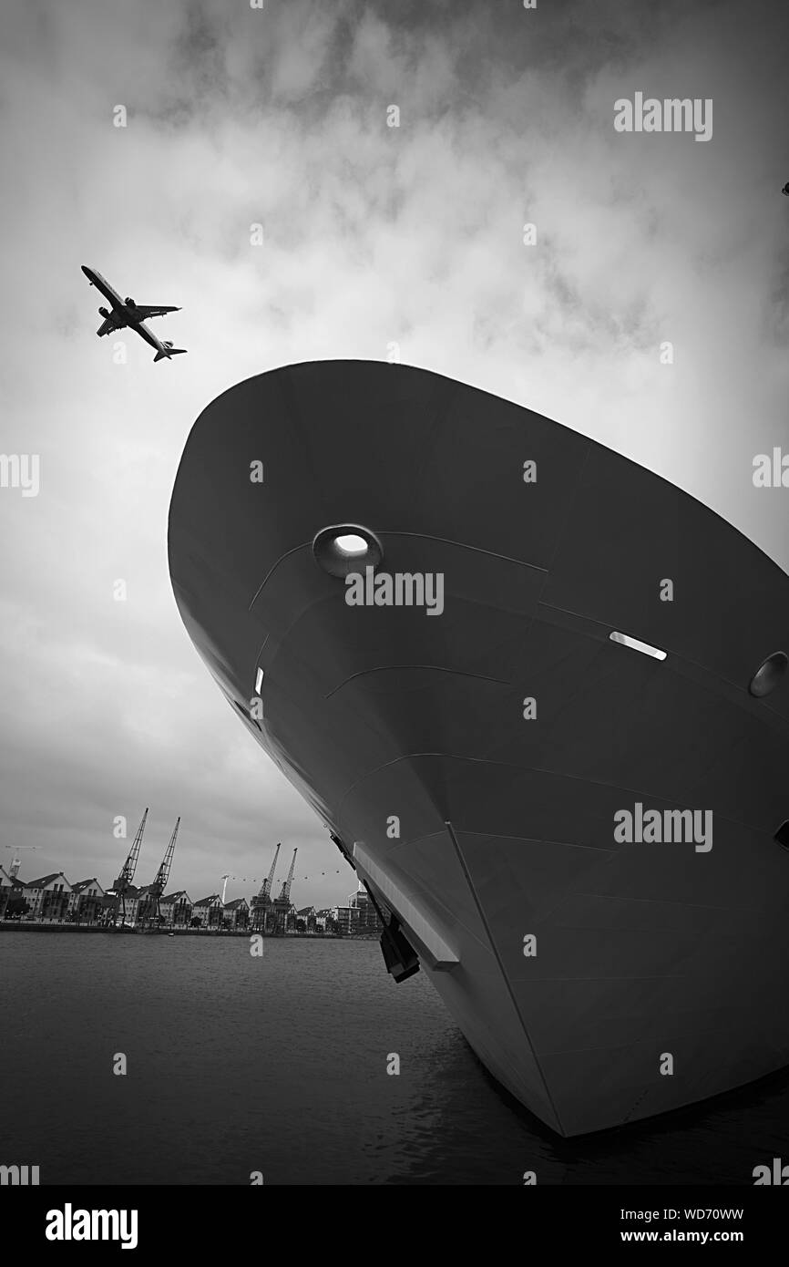Commercial Airplane Flying Over Ship Bow Stock Photo Alamy