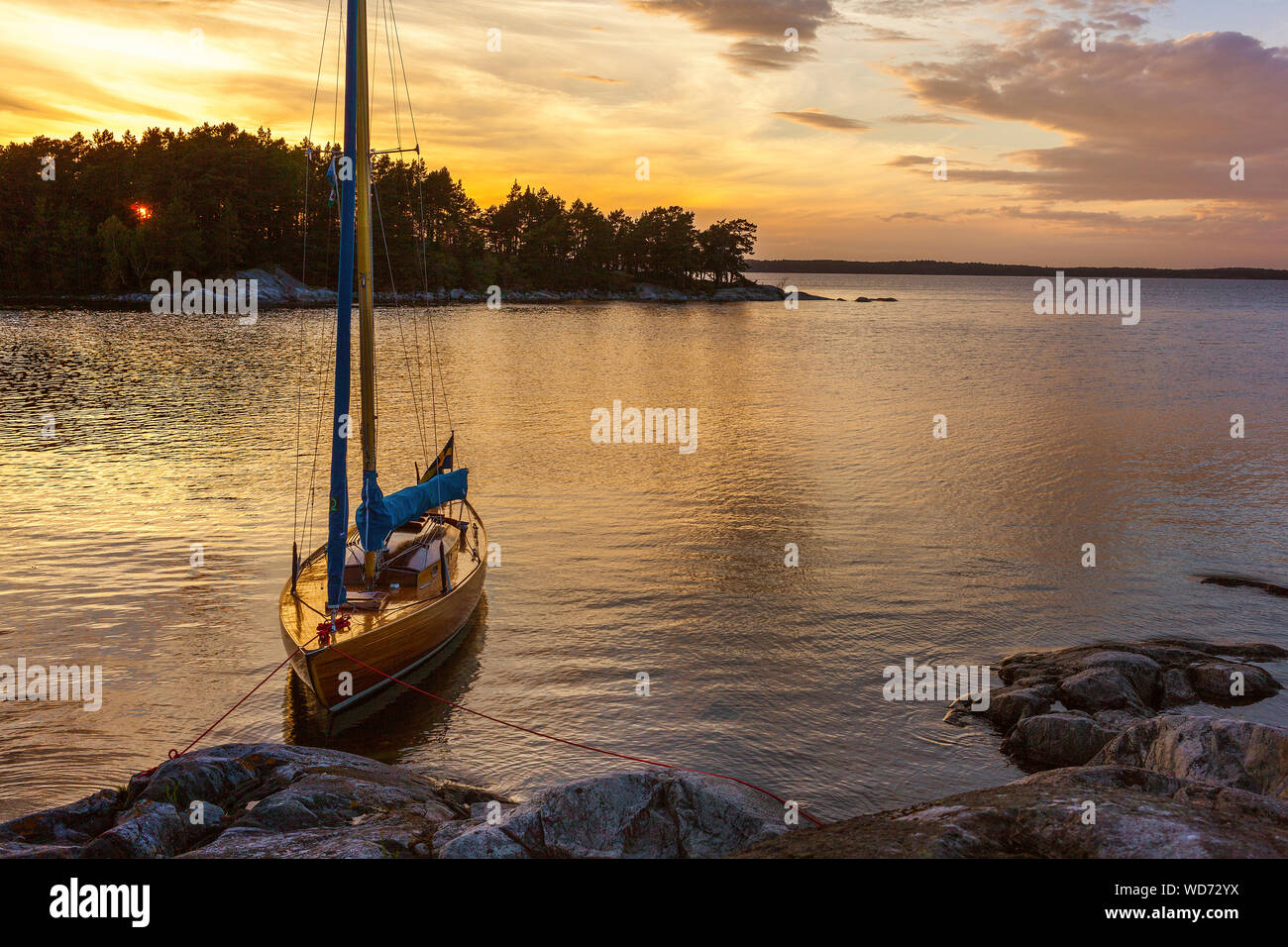 Moored boat at Stockholm archipelago during sunset Stock Photo