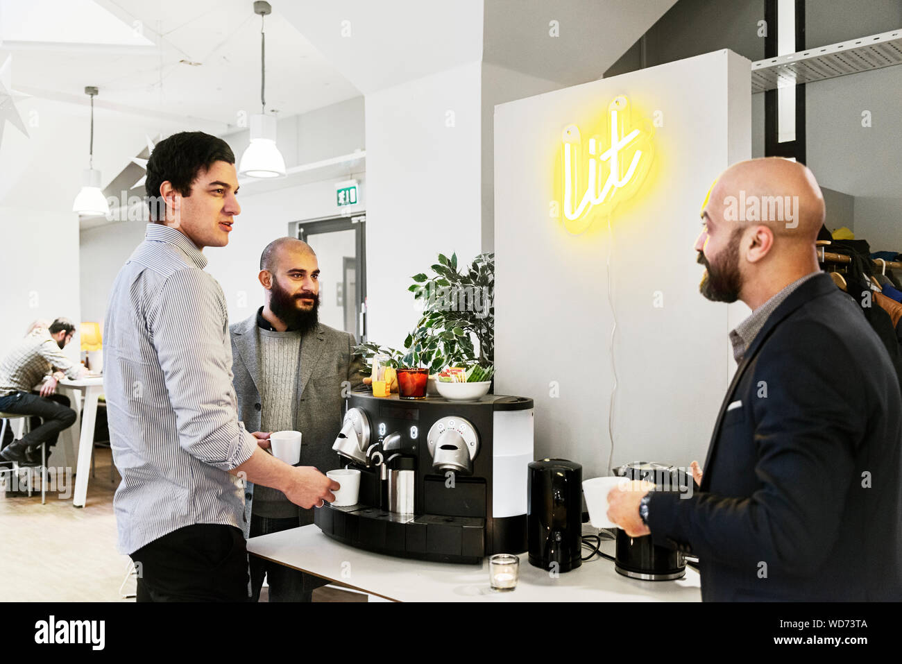 Men getting coffee in office Stock Photo Alamy