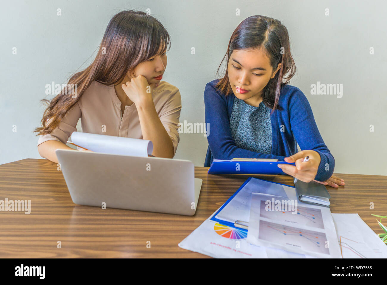 Young business people discussing and analyzing financial statistics documents Stock Photo