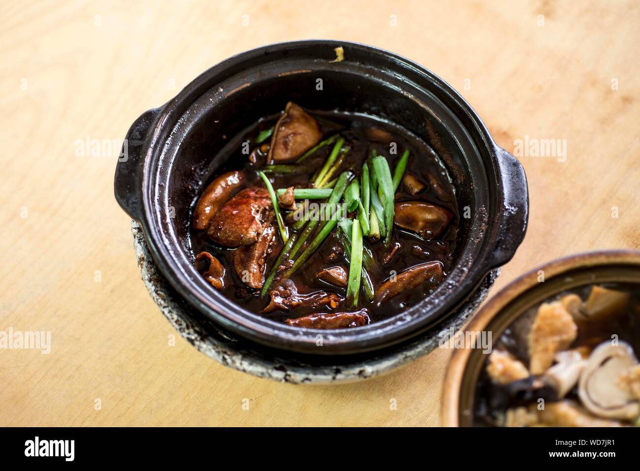 High Angle View Of Livers Served In Clay Pot On Table Stock Photo