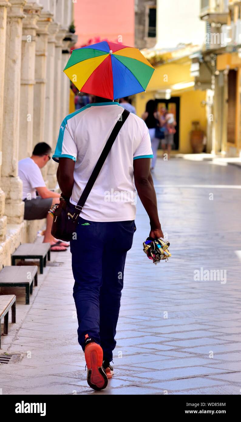 Lucky lucky man carrying watches walking through Corfu old town,Corfu,Kerkyra,Kerkira,Ionian islands,Greece Stock Photo