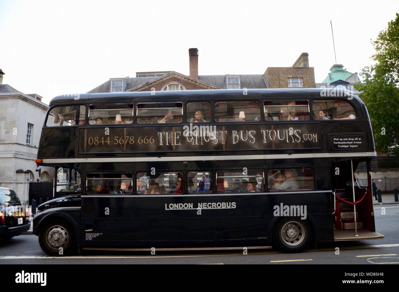 a routemaster bus painted black full of tourists on the ghost bus tours london tour uk Stock Photo
