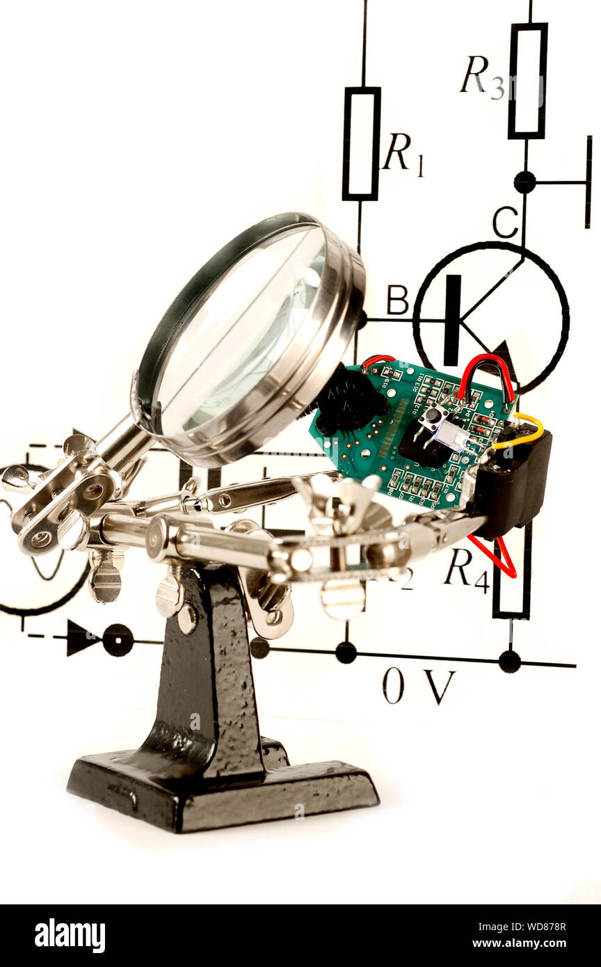 Circuit board under a magnify glass Stock Photo - Alamy