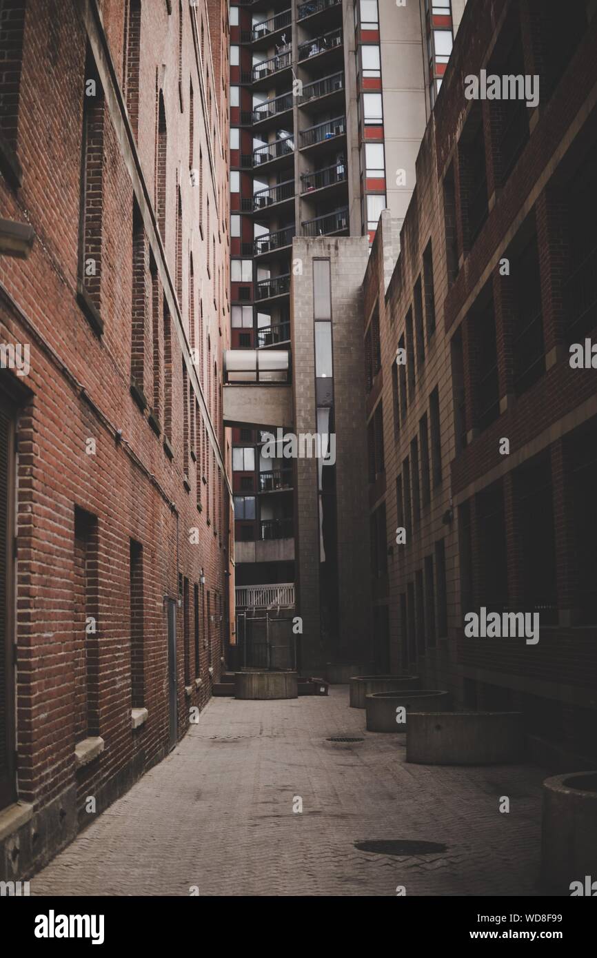Vertical Shot Of A Narrow Alleyway Between Brick Buildings And A High Rise Building In Background Stock Photo Alamy Vertical Shot Of A Narrow Alleyway Between Brick Buildings And A High Rise Building In Background Stock Photo Alamy