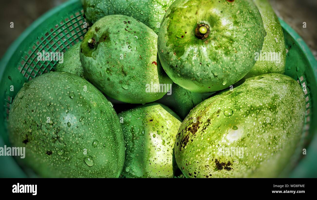 Close-up Of Green Mangoes In Basket Stock Photo