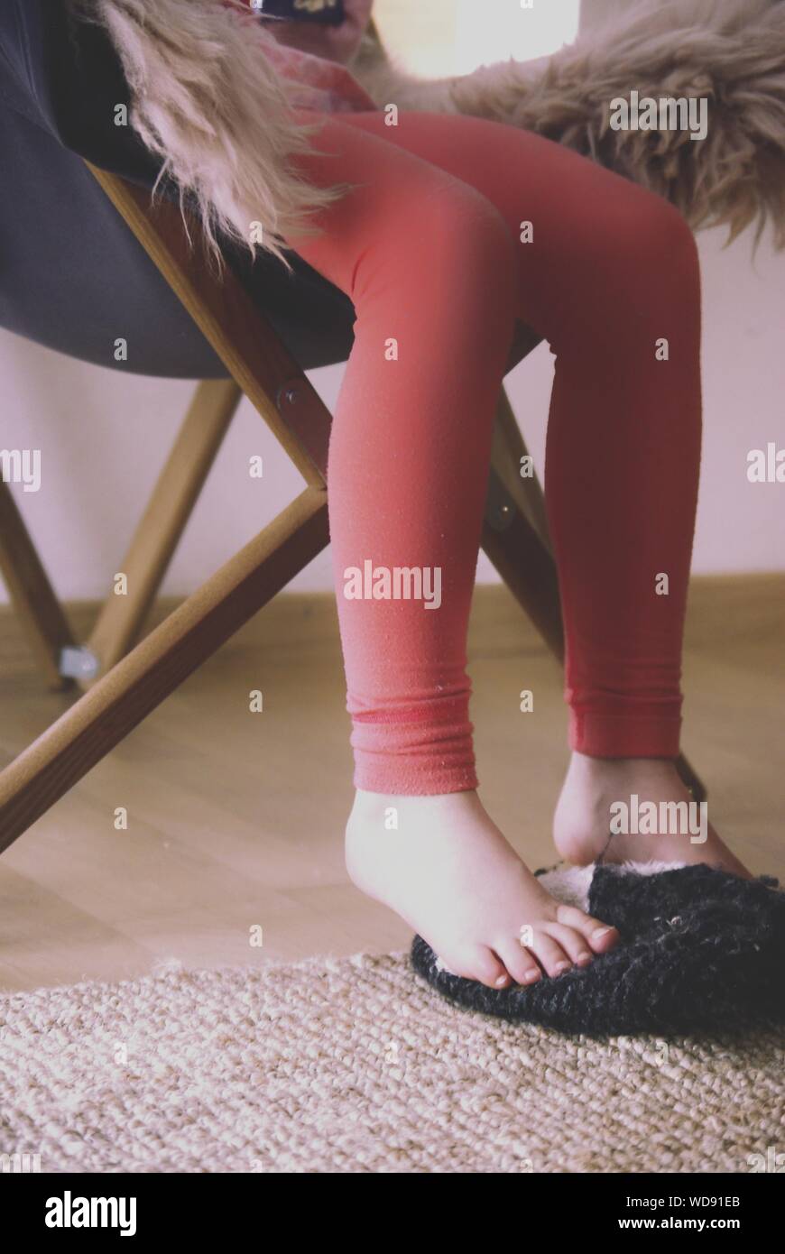 Woman standing leg on chair hi-res stock photography and images - Alamy