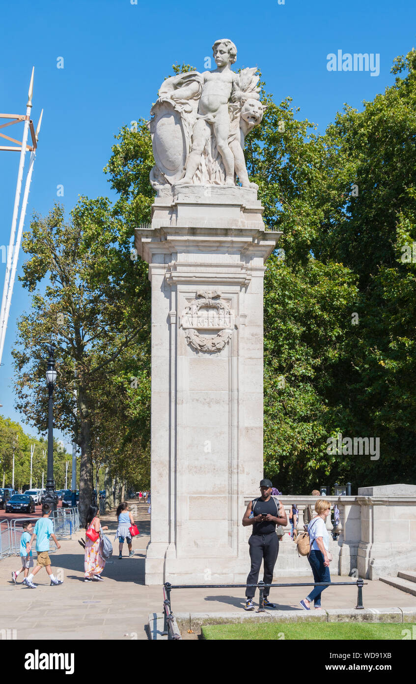 Stone pillar or plinth with statue at South & West Africa gate, marking entrance to Buckingham Palace grounds in Westminster, London, England, UK. Stock Photo