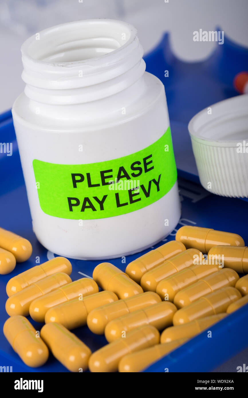 Pharmaceutical tablet counter with bottle with please pay levy on Stock Photo