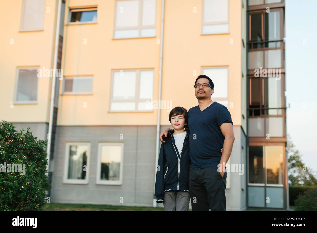 Father with his arm around his son in a city Stock Photo