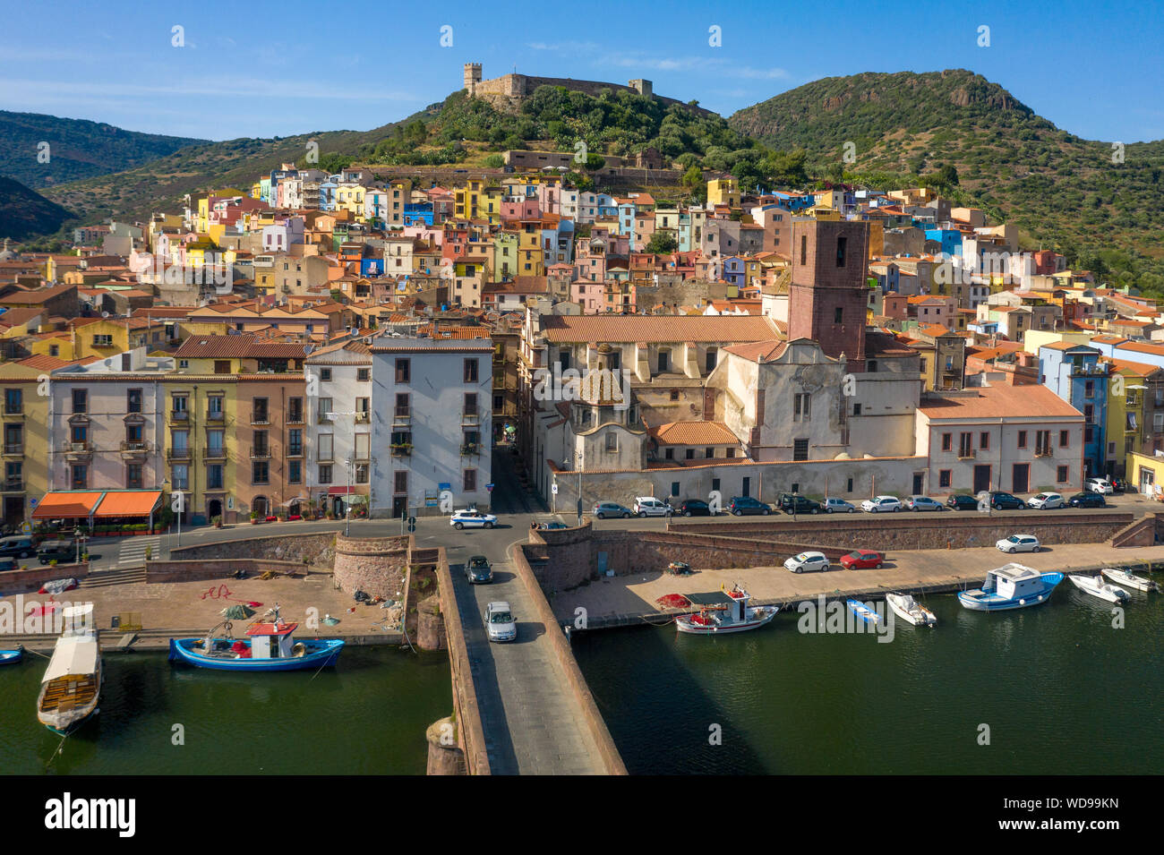 Colorful hillside houses of medieval city Bosa, Sardegna, Italy. Beautiful Mediterranean old town with castle on the hill. At down, bridge over Temo r Stock Photo