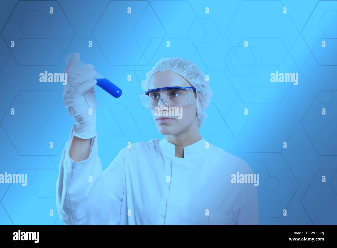 chemist examines a sample in a reagent glass Stock Photo
