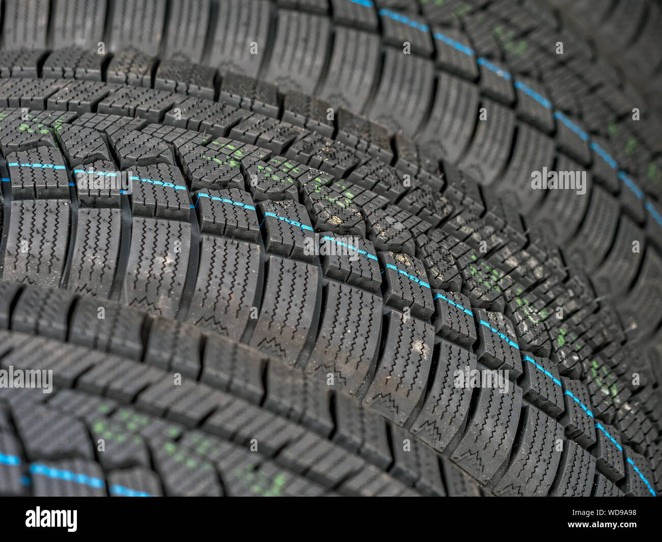 Closeup of row of new winter car tires Stock Photo