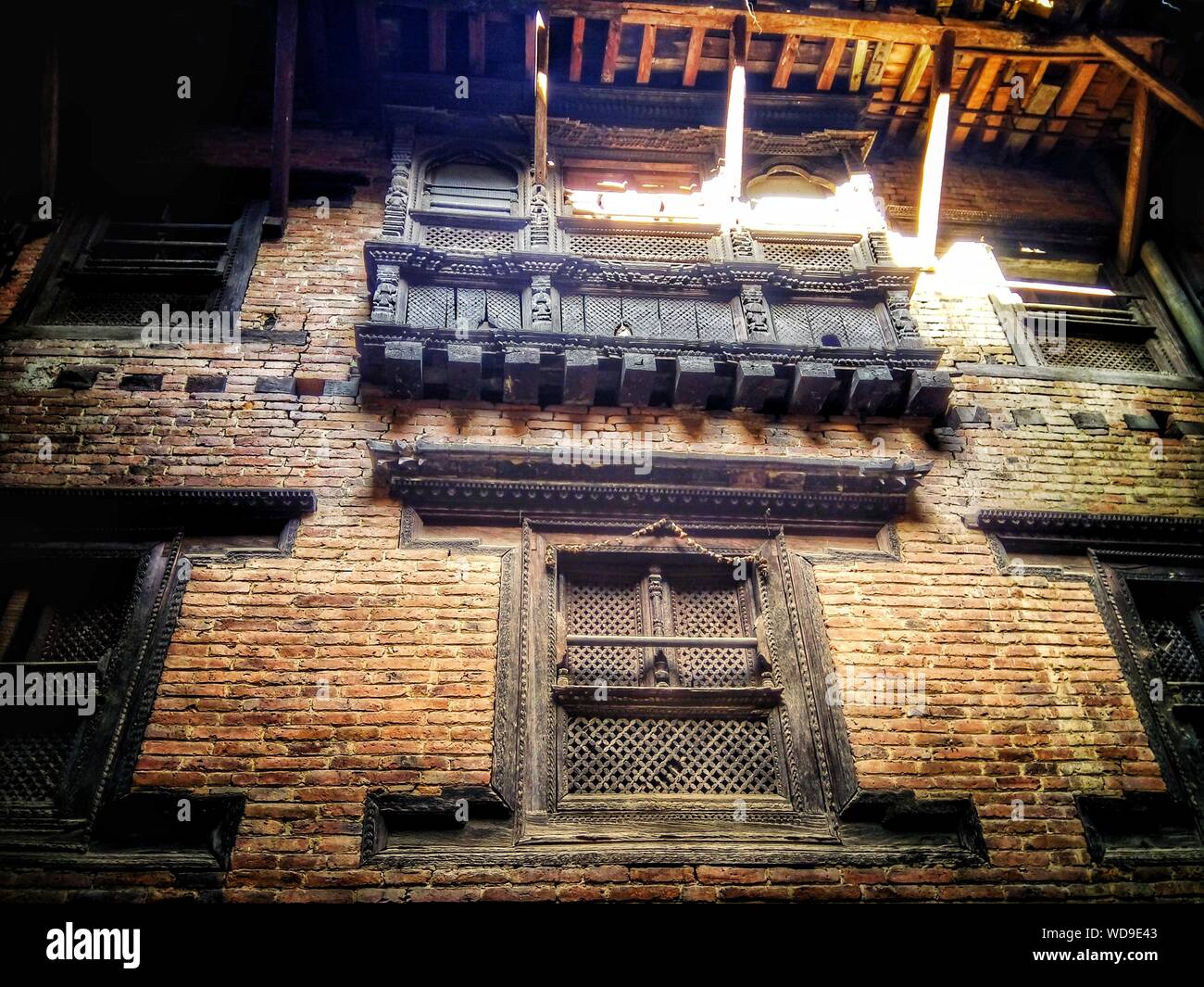 Low angle shot of a brick building with windows at daytime Stock Photo ...