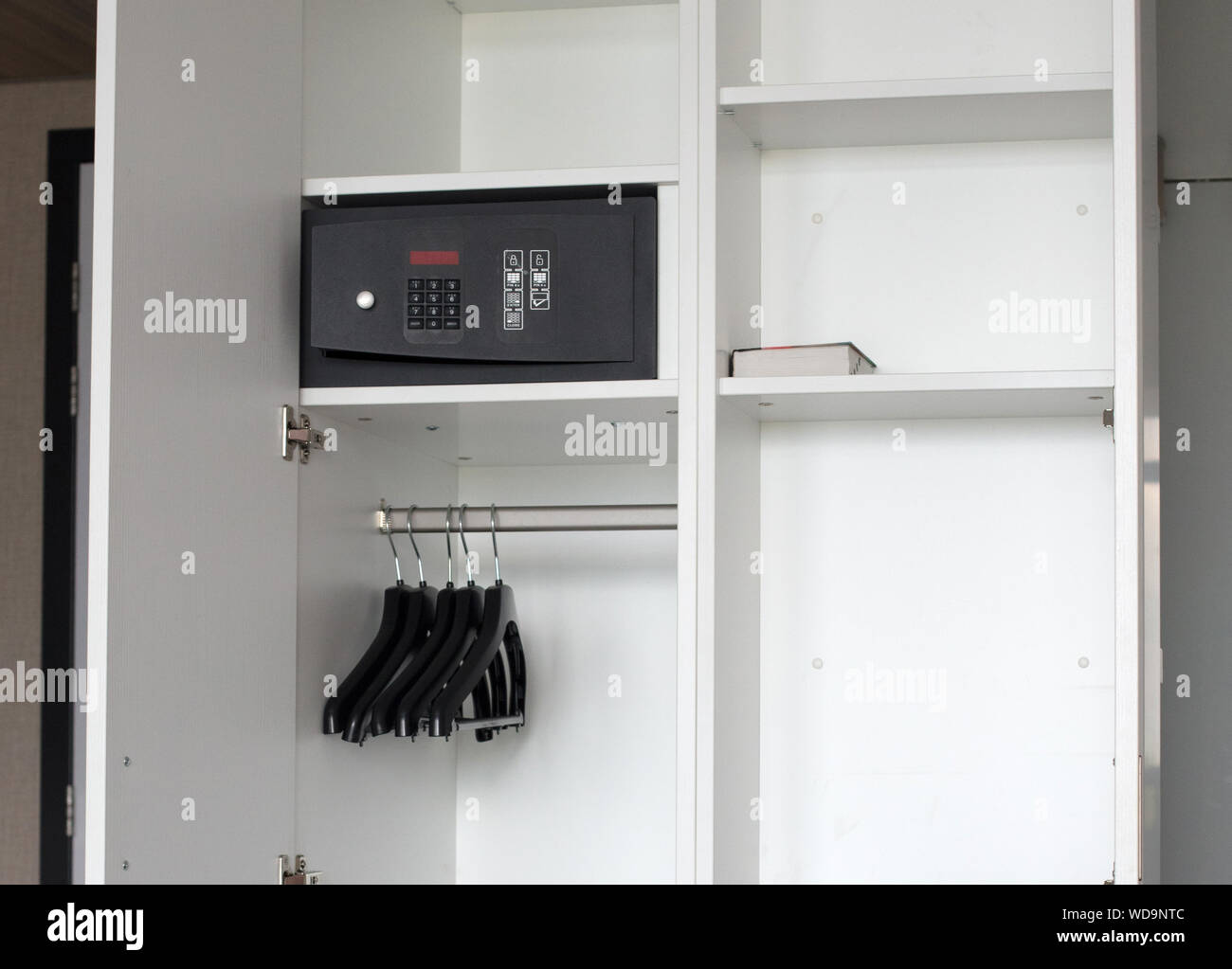 Safe box in a hotel room, white closet Stock Photo Alamy