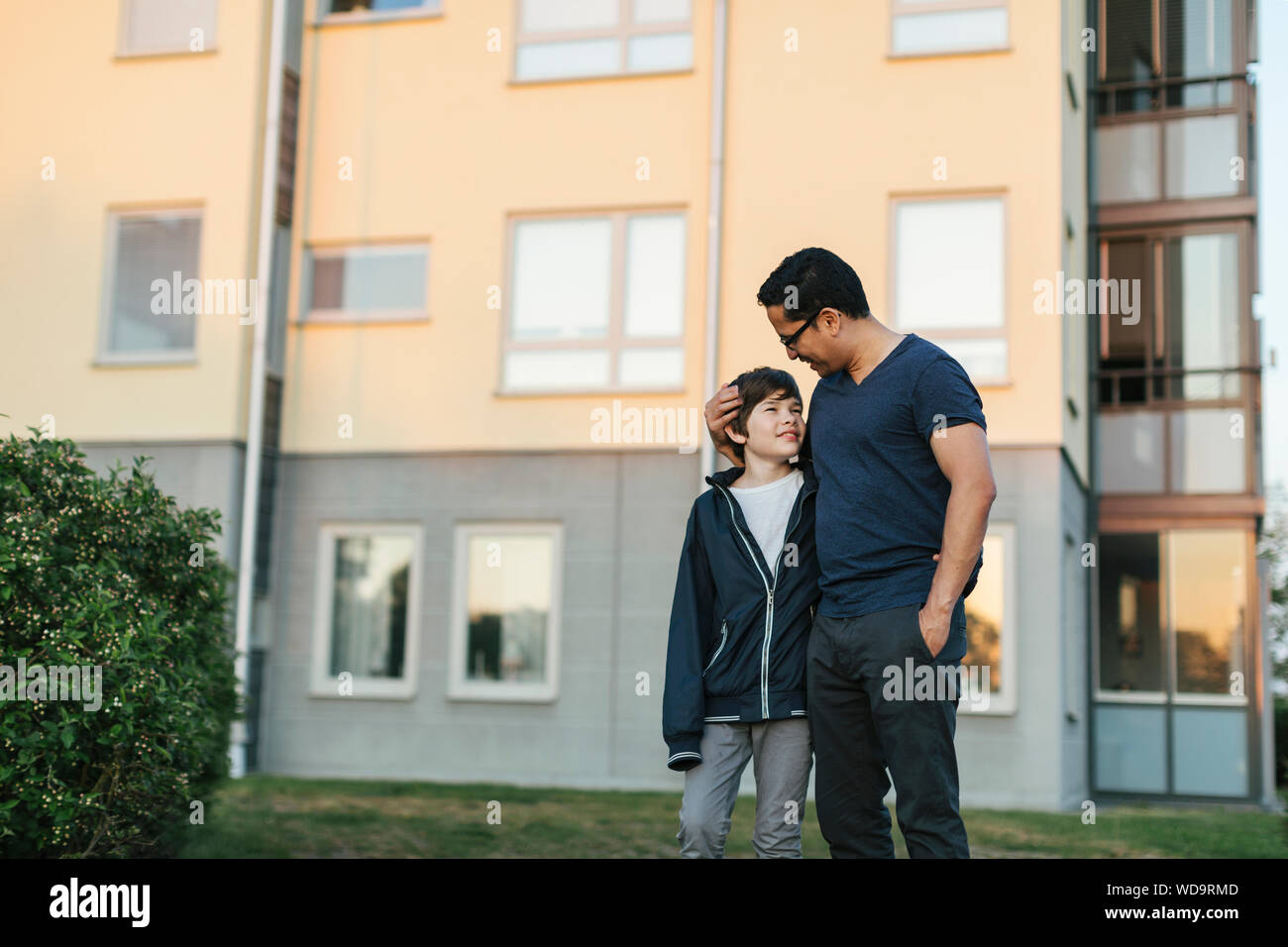 Father with his arm around his son in a city Stock Photo