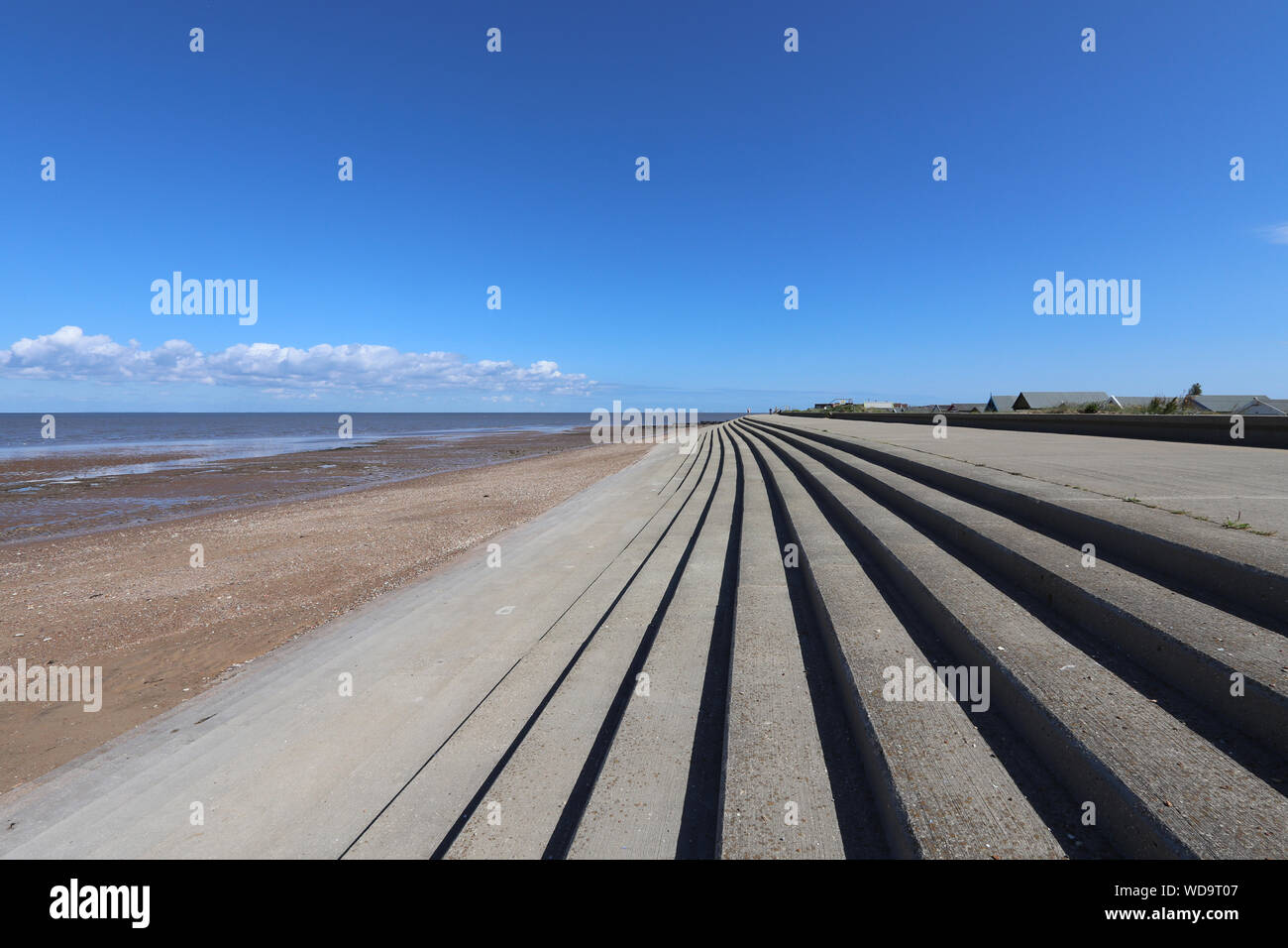 Heacham north on a sunny day with blue clear skies. Shoreline and beach in view. Stock Photo