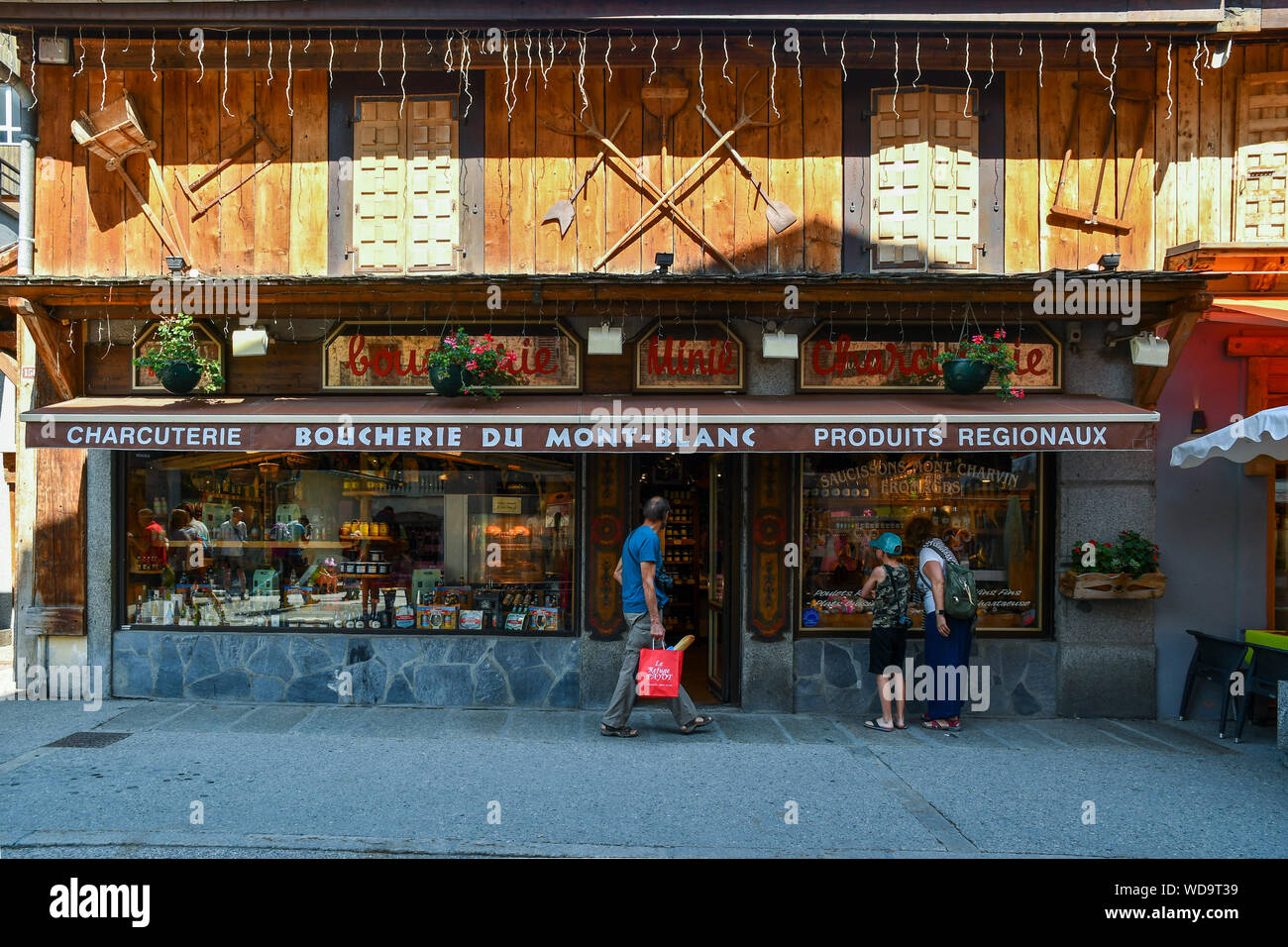 The typical wooden facade of a deli and butcher shop that sells local food in the historical centre of Chamonix-Mont-Blanc, Haute Savoie, France Stock Photo