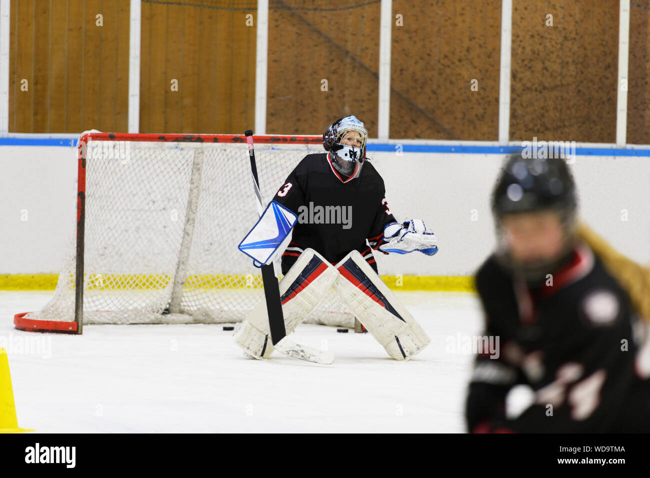 Girl in goalkeeper uniform during ice hockey training Stock Photo Alamy