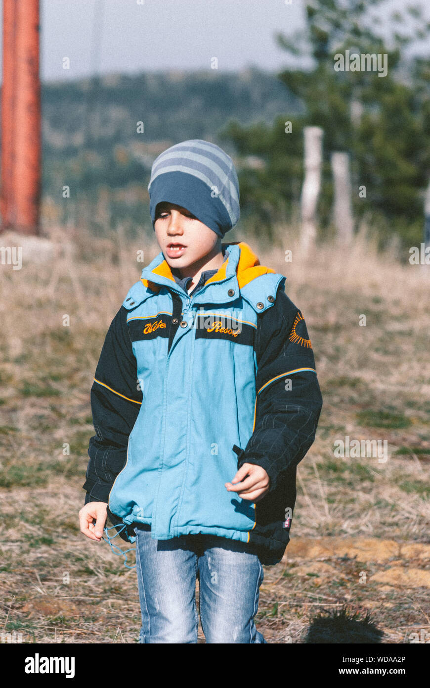 Boy Wearing Warm Clothing On Field Stock Photo