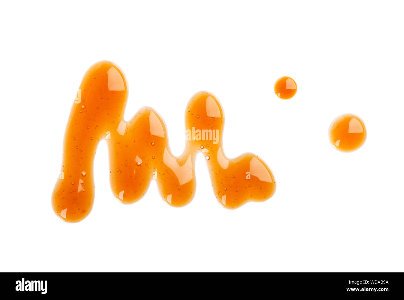 Caramel syrup drizzle isolated on white background. Splashes of sweet