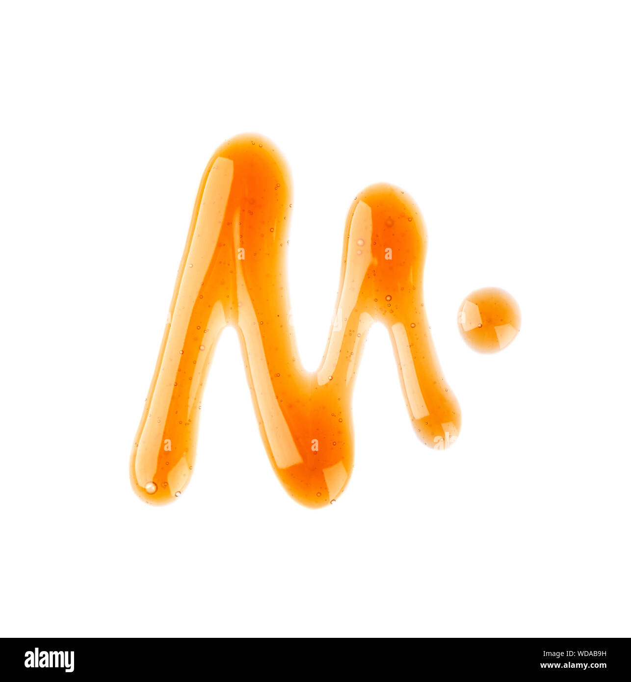 Caramel syrup drizzle isolated on white background. Splashes of sweet