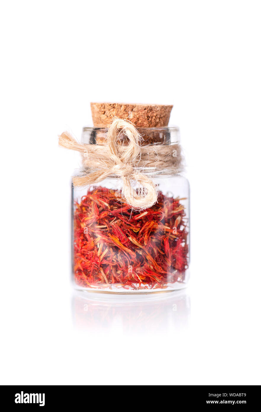 Pile of Saffron in glass jar, isolated on white background. Dried