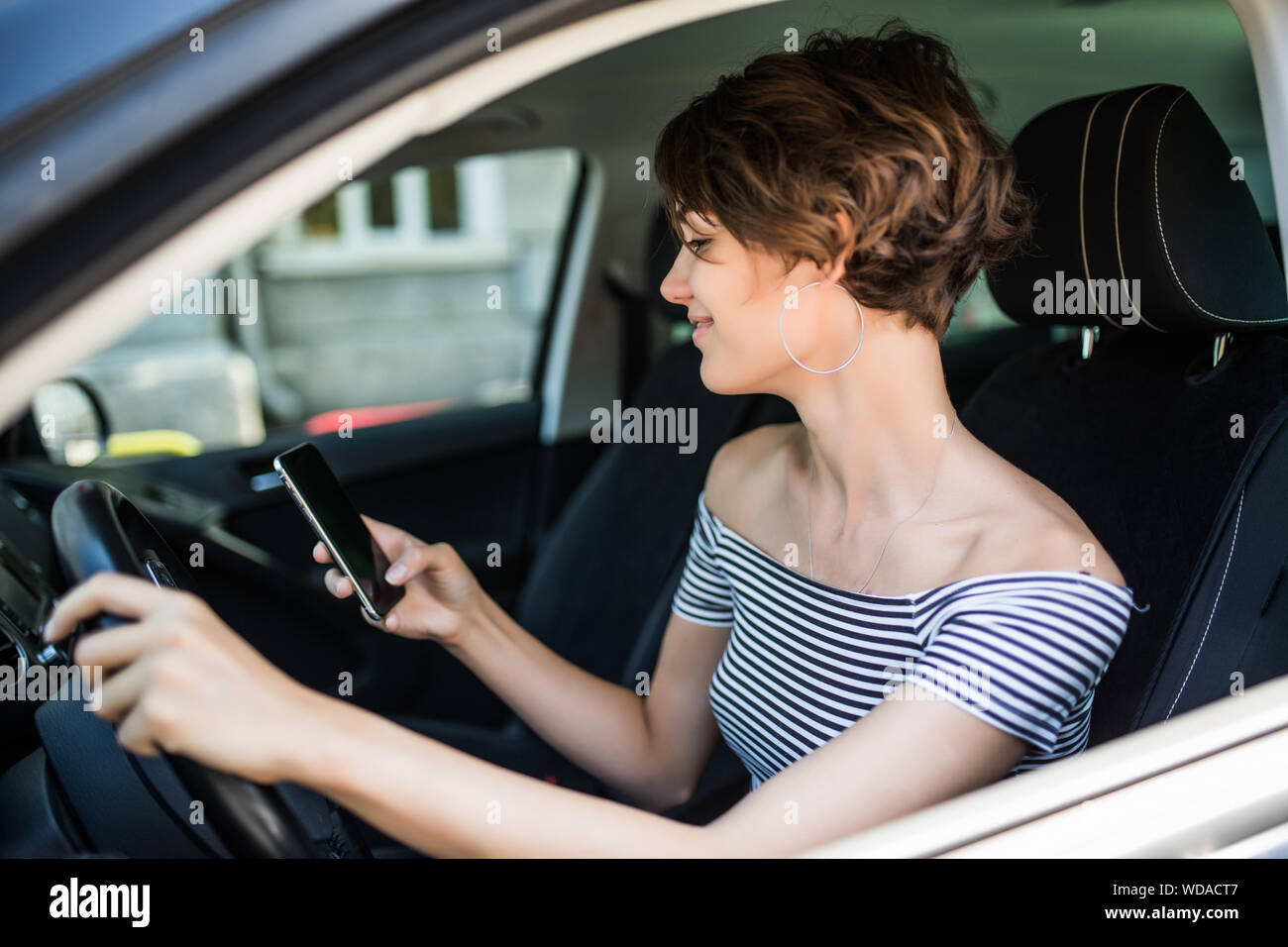 Woman sitting behind steering wheel hi-res stock photography and images ...