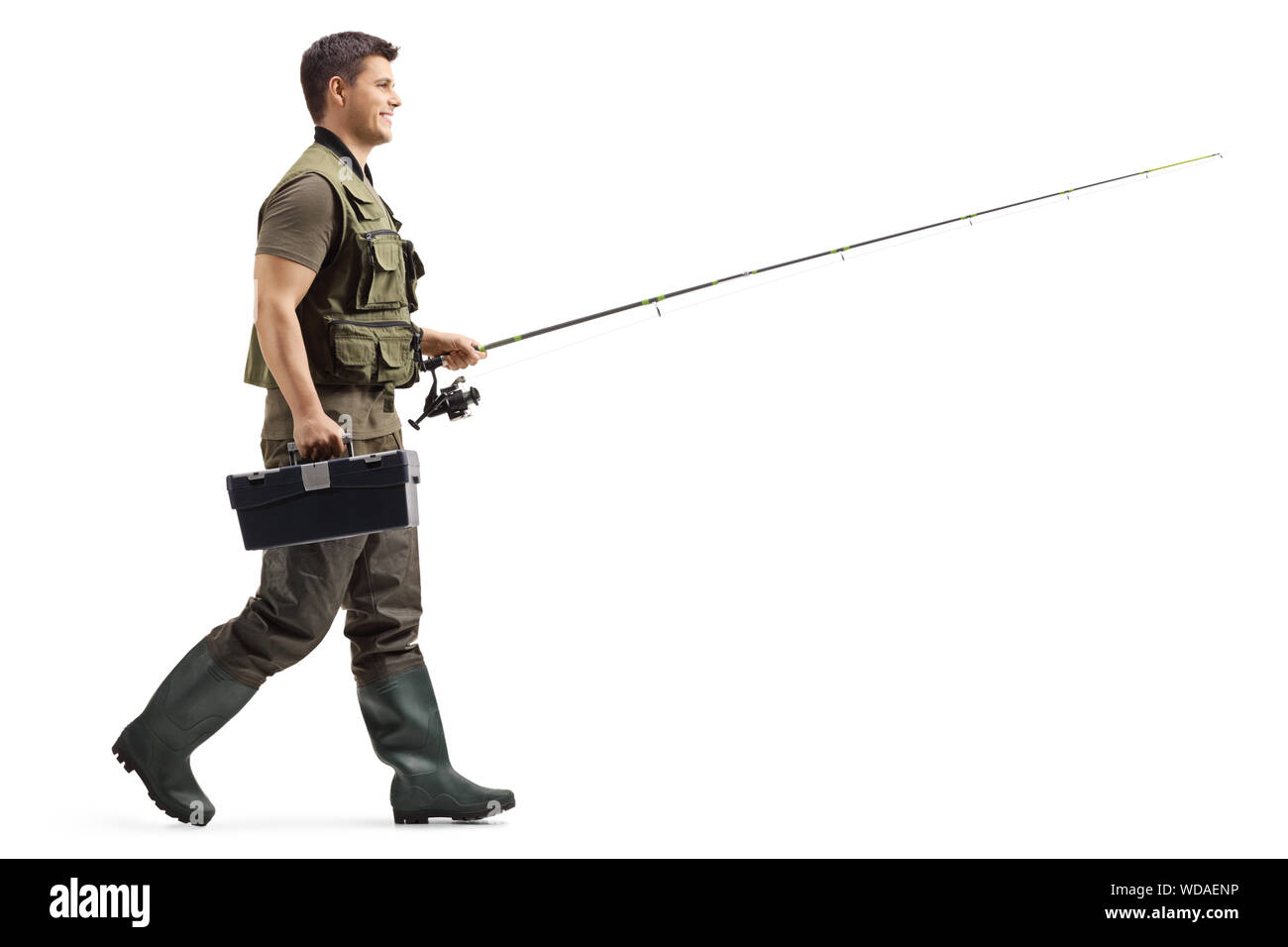 Full length profile shot of a fisherman with a fishing rod walking isolated  on white background Stock Photo - Alamy