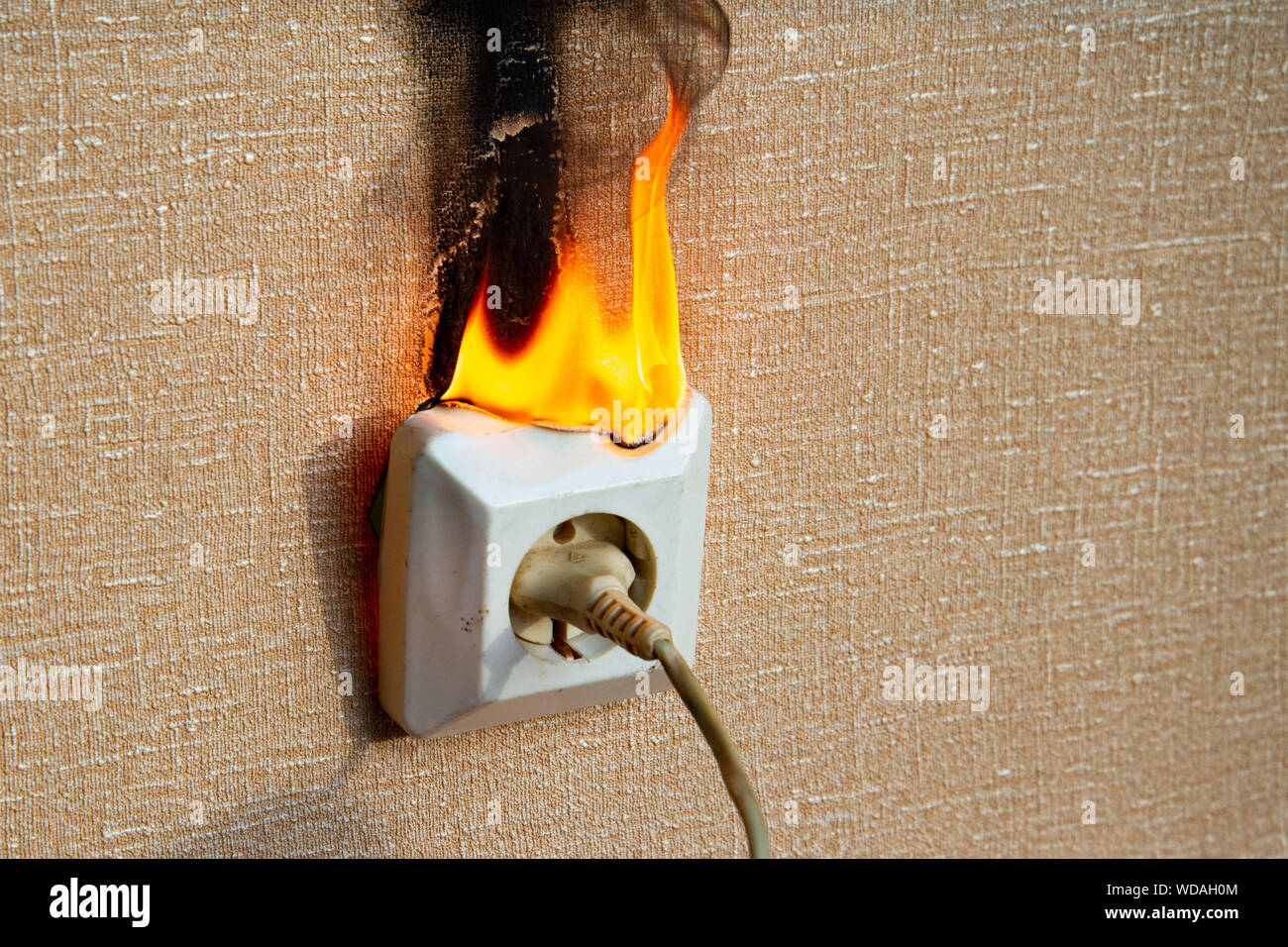 Burning electrical wiring and electrical outlet. Faulty wiring causes