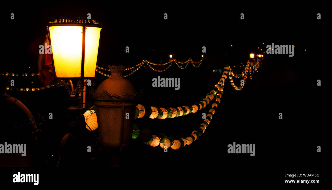 Closeup of the traditional paper lanterns and street lights during the April Fair in Seville, Andalusia, Spain Stock Photo