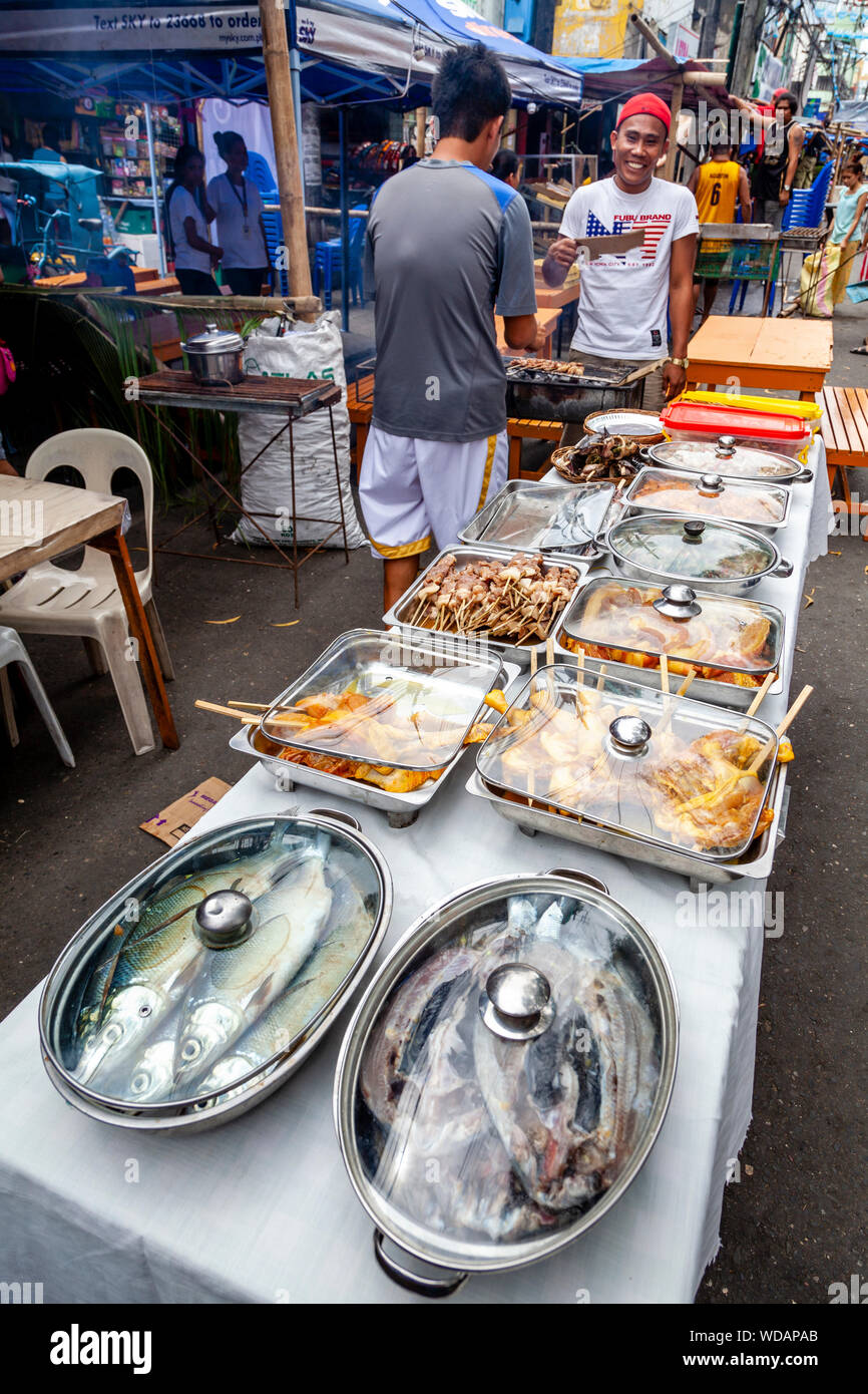 A Display Of Restaurant Food Dishes In The Street During The Dinagyang Festival, Iloilo City, Panay Island, The Philippines Stock Photo