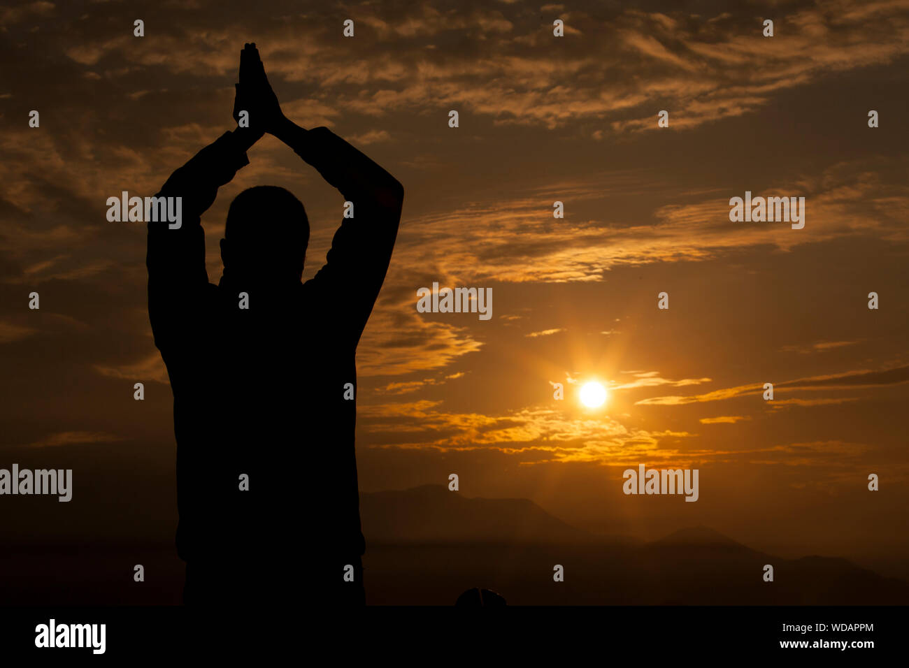 Silhouette of people praying hi-res stock photography and images - Alamy