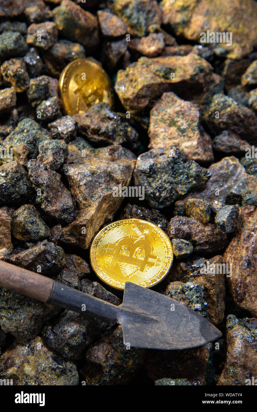 Top view close-up of a bitcoin stack of gold coins on a background of  stones with a shovel. Cryptocurrency mining concept Stock Photo - Alamy