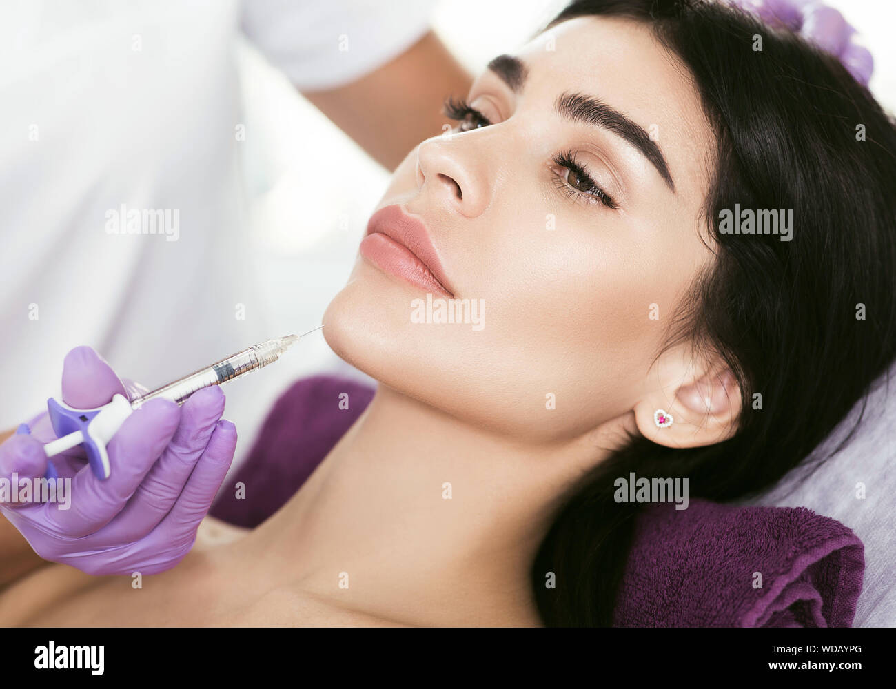 Cosmetic face treatment. Beautiful mid aged woman getting face injection, lifting effect, beauty injections for face lift and tighten face contour Stock Photo