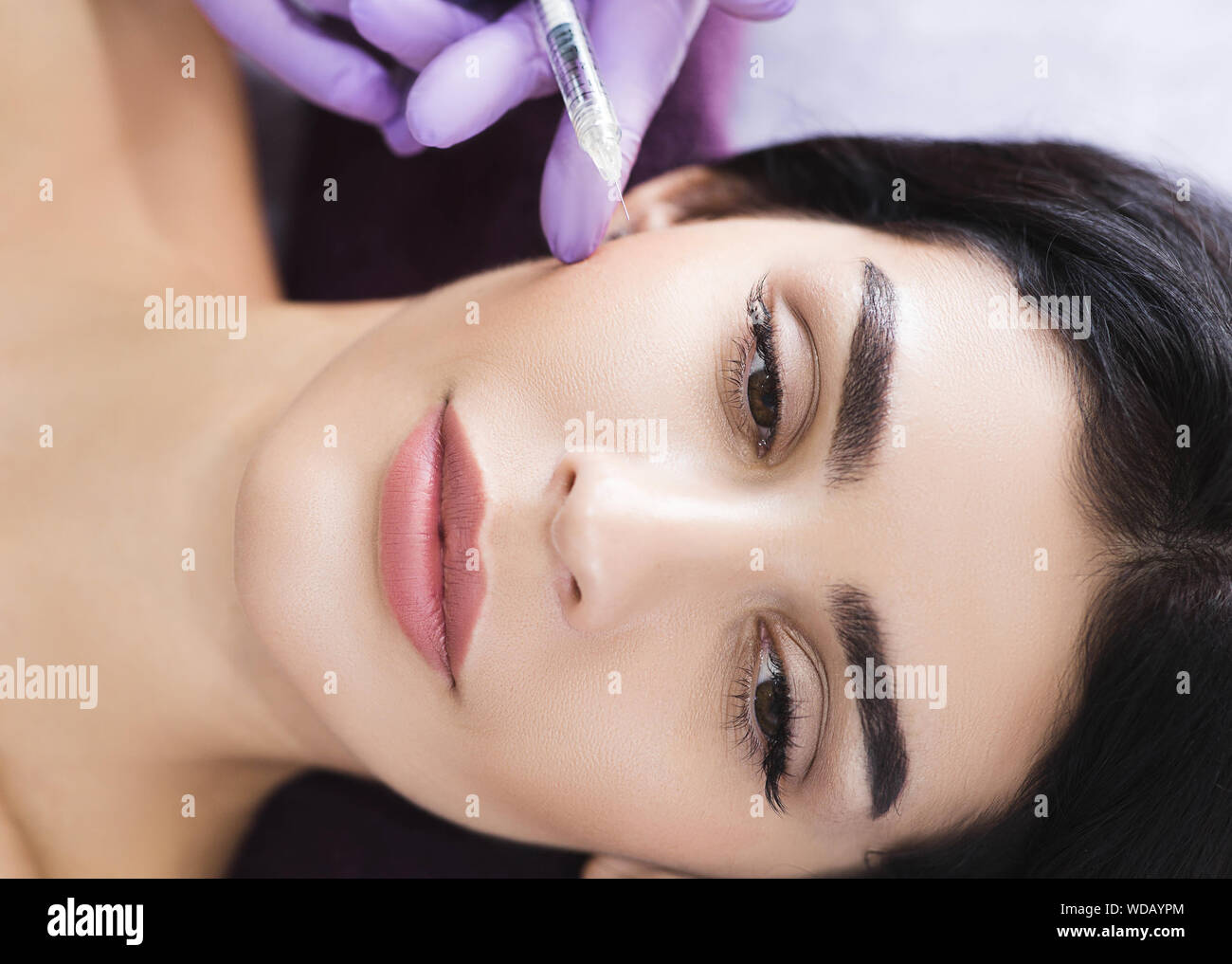 Cosmetic face treatment. Beautiful mid aged woman getting face injection, anti wrinkles effect, beauty injections for skin and face rejuvenation Stock Photo
