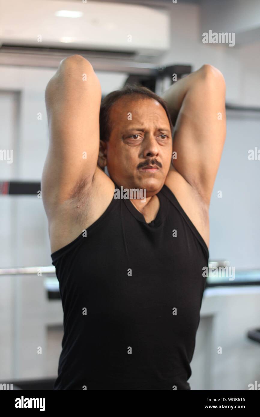 Determined Man Exercising In Gym Stock Photo
