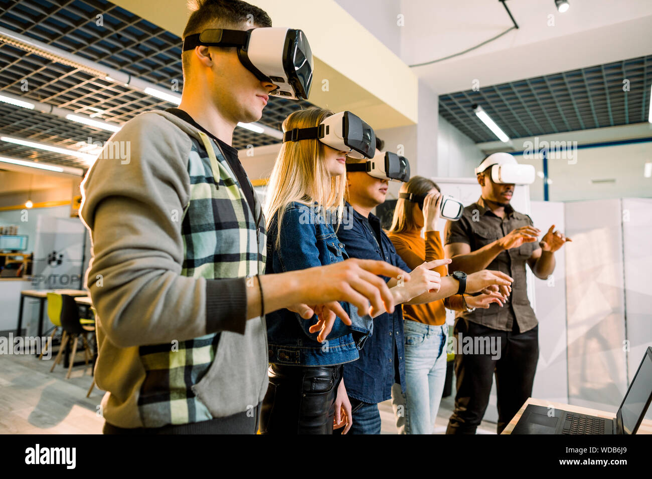 Team of developers working with virtual reality glasses during a ...