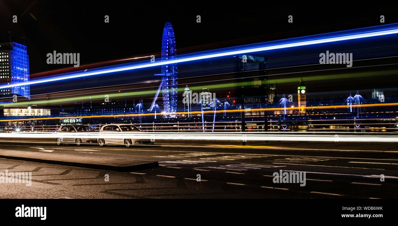 Side View Of Light Trails On Urban Street Stock Photo