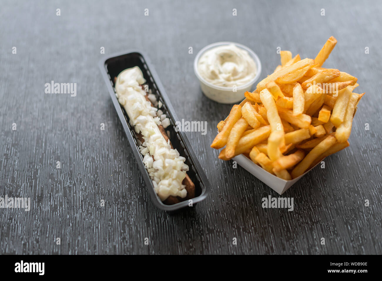 Frikandel with sauce and french fries. Horizontal image. Top view. Stock Photo