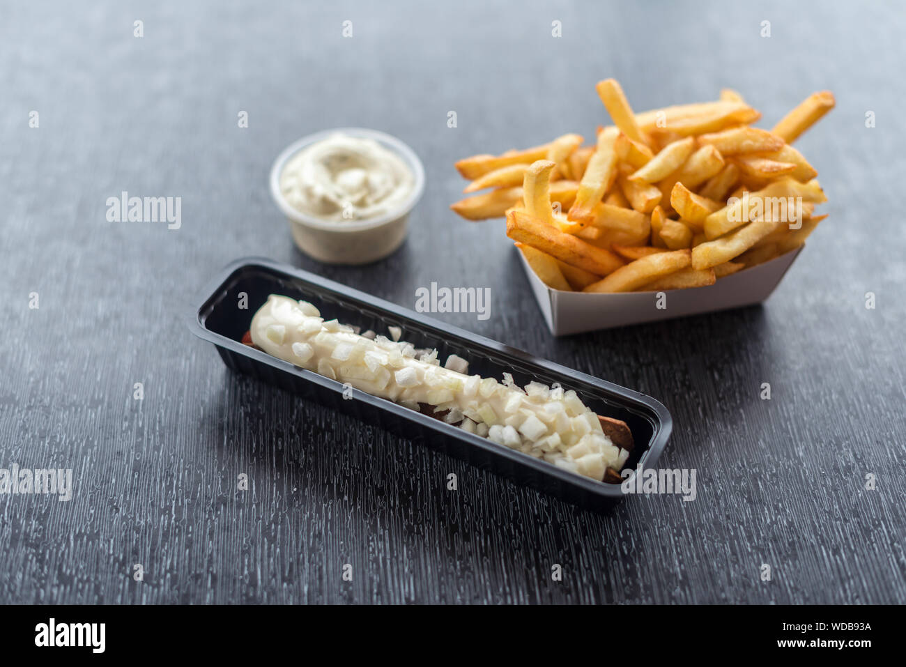 Frikandel with sauce and french fries. Horizontal image. Stock Photo