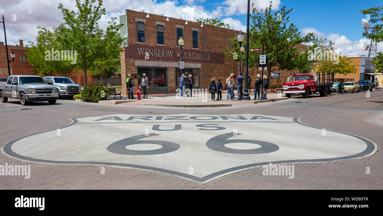 Winslow Arizona, US. May 23, 2019. Historic route 66 sign on the street, Tourists looking at the Standin on the corner statue, Stock Photo