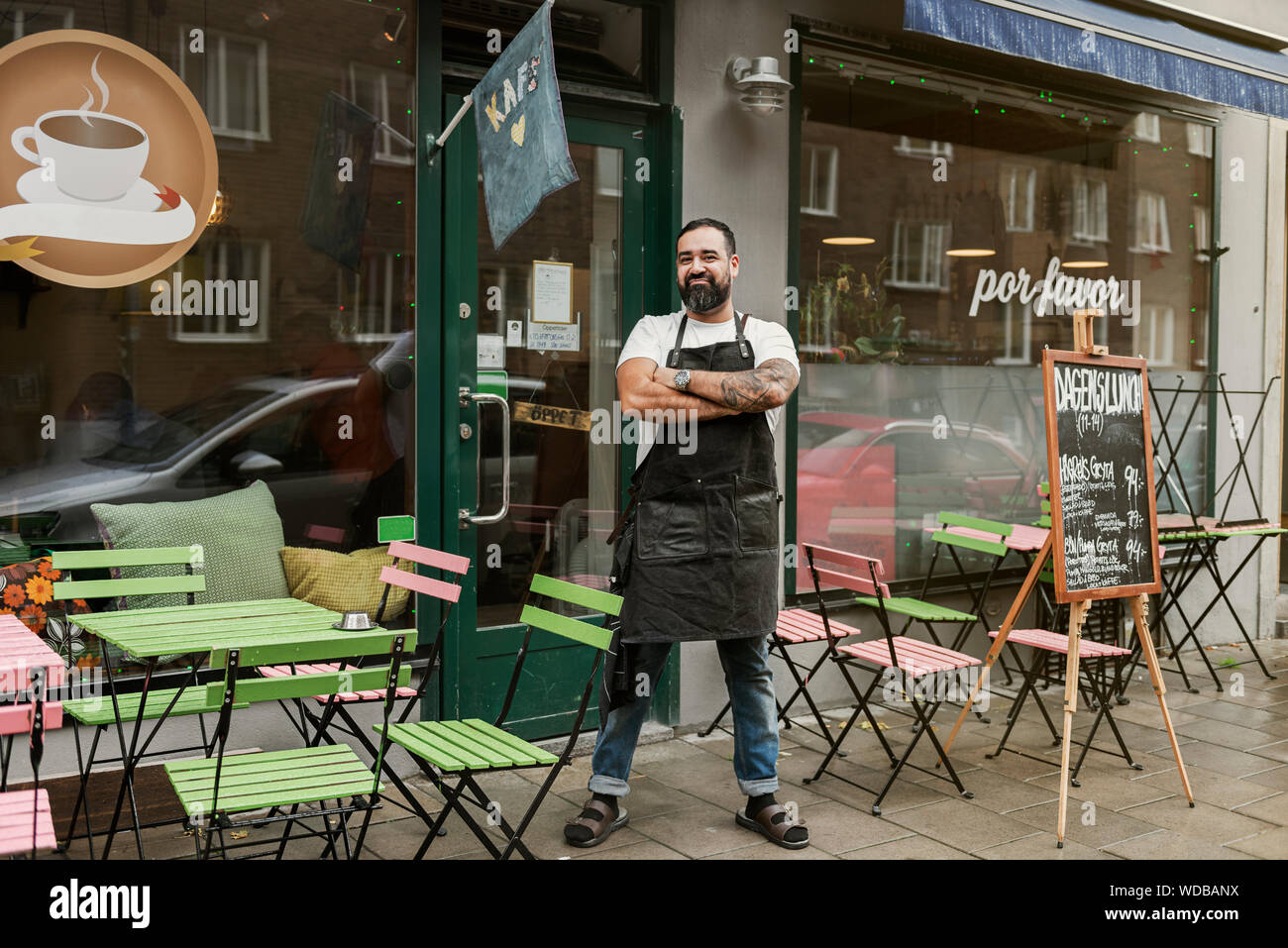 Small business owner outside his cafe Stock Photo